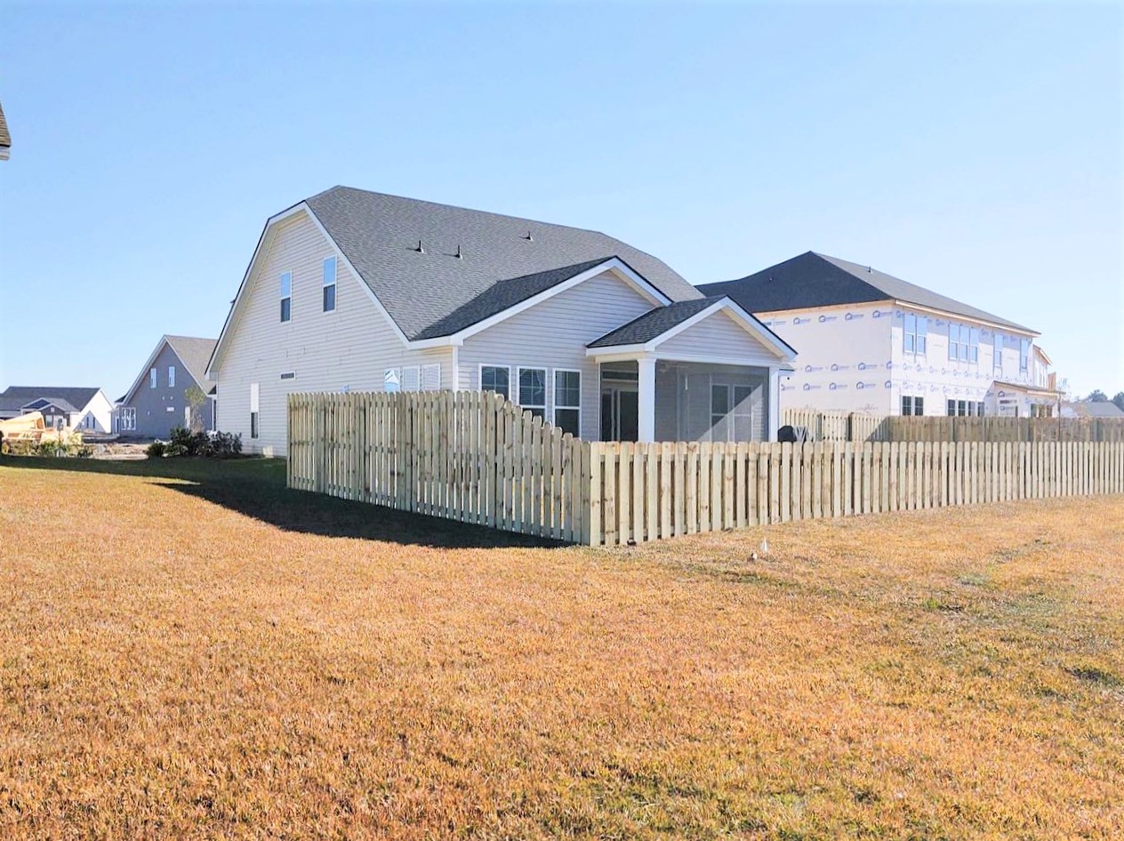 Photo of a semiprivate wood fence around a home in a development