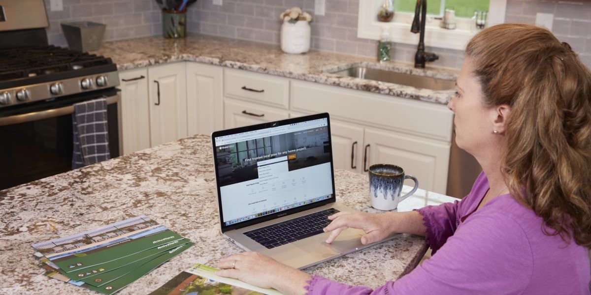 Photo of a woman sitting at her laptop at a desk