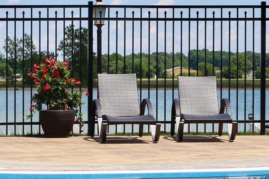 Photo of a black aluminum fence around a pool