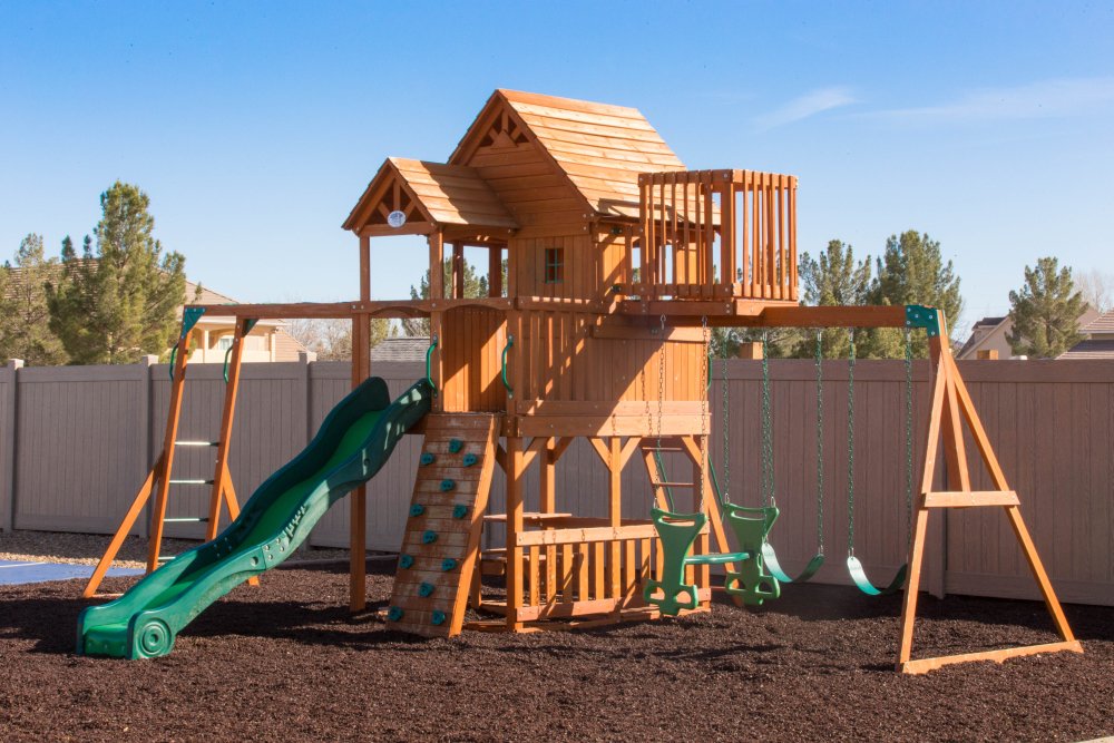 Photo of a swing set with a vinyl fence surrounding it