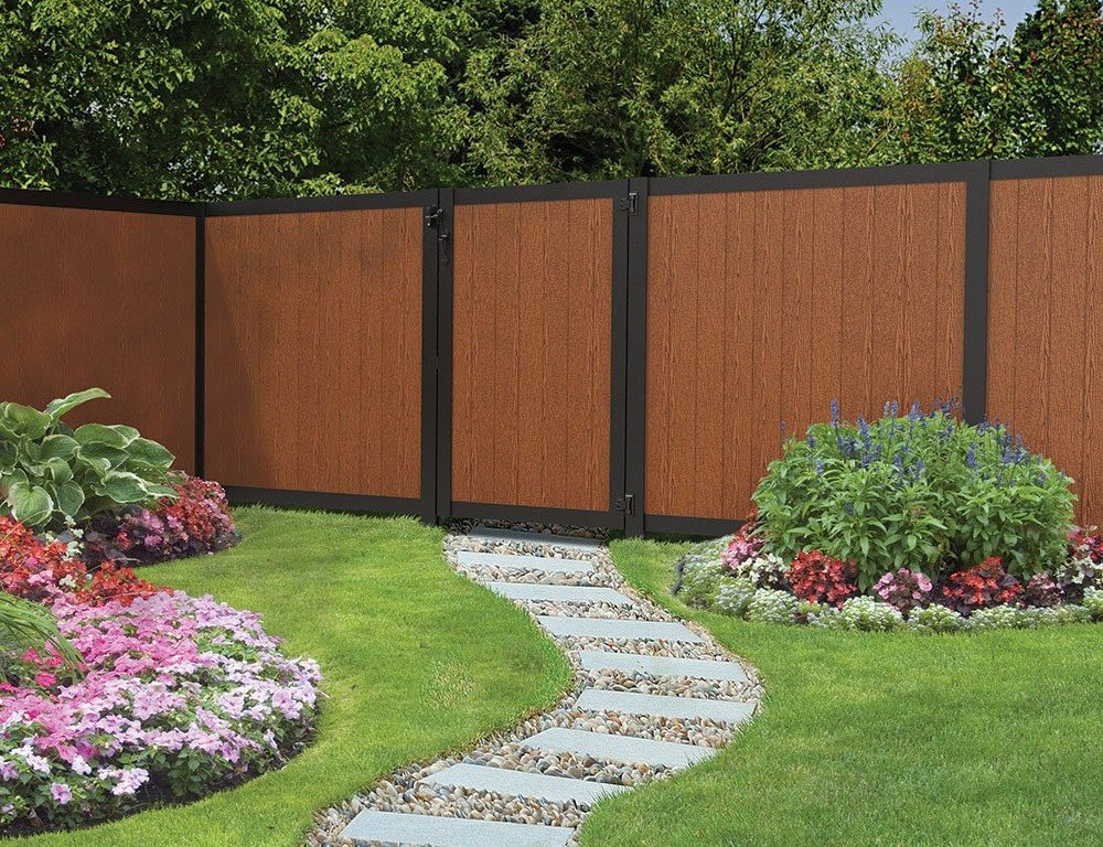 Photo of a landscaped yard with a vinyl fence