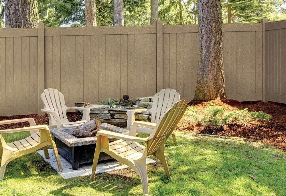 Photo of a tan privacy vinyl fence in a backyard