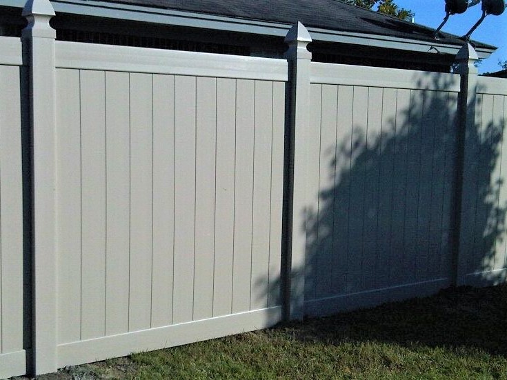 Photo of a tan vinyl privacy fence